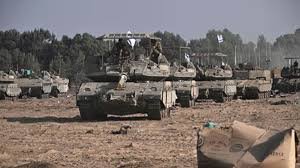 Tanques militares en formación sobre terreno arenoso.